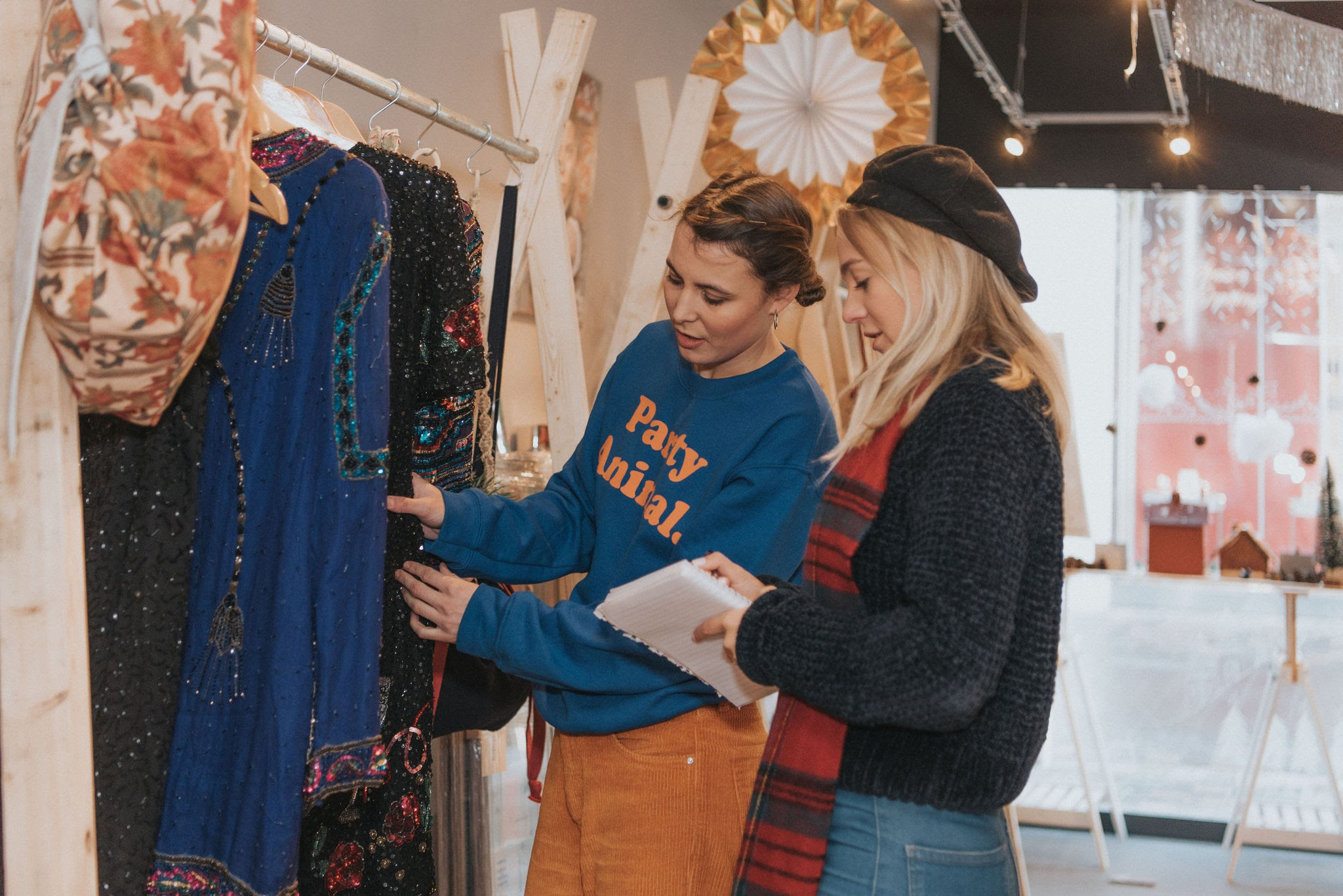 Twowomenchoosingclothesforpopupsection